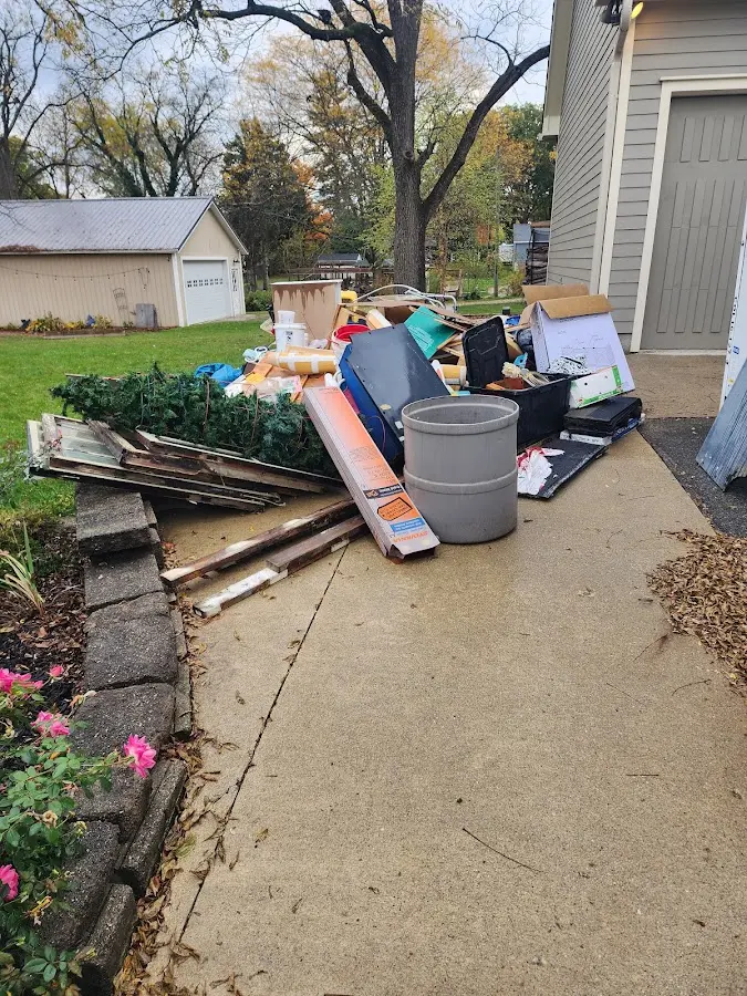 Dumpster being loaded with debris for Commercial Dumpster Rental in Rowley